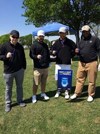 A group of golfers taking a shot with Pandell