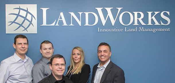Pandell management posing within the LandWorks Inc. office