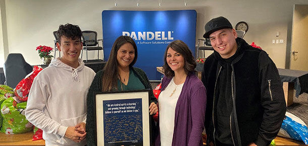 USAY charity members pose for a picture inside the Pandell office