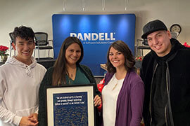 USAY charity members pose for a picture inside the Pandell office