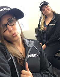 Two pandell employees show off their Pandell branded apparel